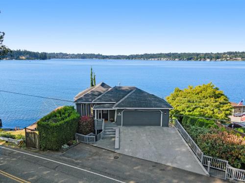 a house on the shore of a large body of water at Lakefront Oasis at Lake Stevens in Lake Stevens