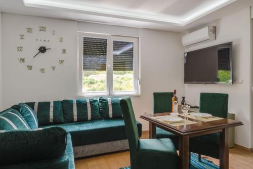 a living room with a couch and a table at Panorama - PRESTIGE in Vrnjačka Banja