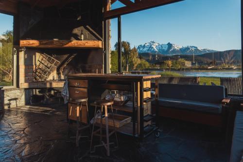 a bar in a room with a view of a lake at Los Rebeldes in Baggle