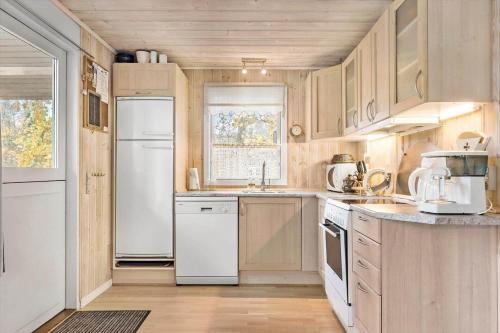 a kitchen with a white refrigerator and a sink at 9004-Hasle-Klympen-2 in Hasle