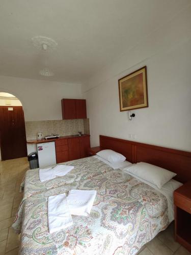a bedroom with a large bed with two pillows on it at Panorama apartments in Agios Gordios