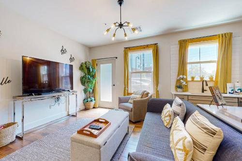 a living room with a couch and a tv at The 1865 #113 in Nashville