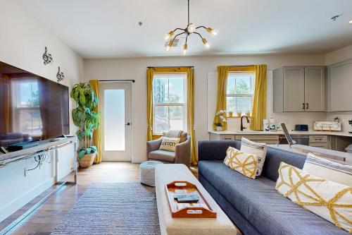 a living room with a couch and a kitchen at The 1865 #113 in Nashville