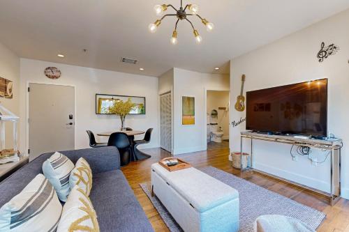 a living room with a couch and a tv at The 1865 #113 in Nashville