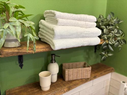 a bunch of towels on a shelf in a bathroom at Old Town Sibiu Apartment - Historical Center Residence in Sibiu