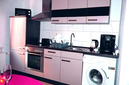a kitchen with a washing machine and a washer at Holiday Rhein1 in Boppard