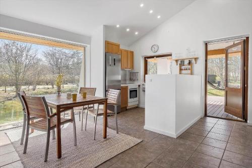 a kitchen with a table and a refrigerator at LF16311-Nibe-Pirken-19 in Nibe