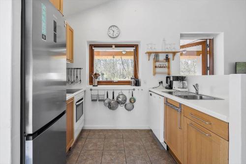 a kitchen with a stainless steel refrigerator and a window at LF16311-Nibe-Pirken-19 in Nibe