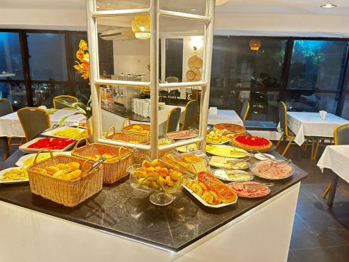 a buffet with many different types of food on a table at Atlantico Flat Santos in Santos