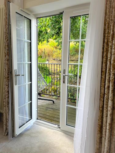 a sliding glass door with a view of a balcony at Peak District Period Property near Chatsworth House in Bakewell