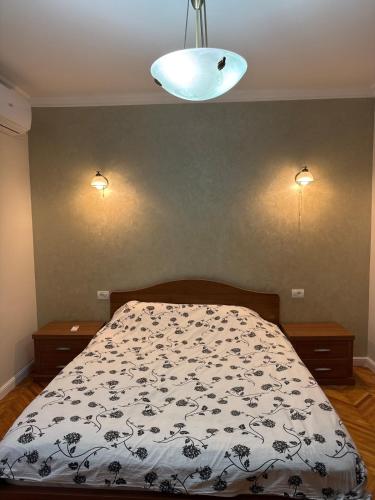 a bedroom with a bed with a black and white comforter at Apartment for rent in Baile Herculane in Băile Herculane