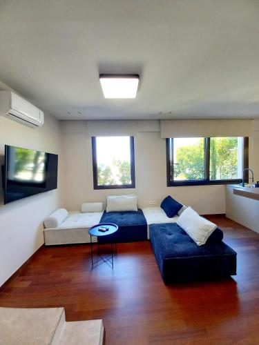 a living room with two beds and a couch at Ianos Living Spaces - 01 in Kórinthos