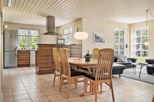 a kitchen and dining room with a table and chairs at LF584-Hurup-Thy-Haettemagevej-4 in Sindrup