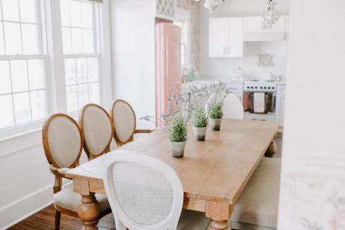 a dining room with a wooden table and chairs at The Pink House in Downtown Clarksville in Clarksville