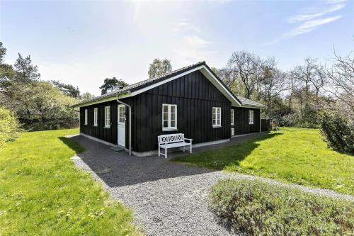 a black house with a sign in front of it at 3638-Nexo-Hedevej-10-C in Neksø