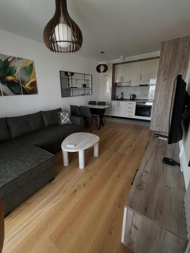 a living room with a couch and a table at Stan na dan Sneguljica in Sarajevo