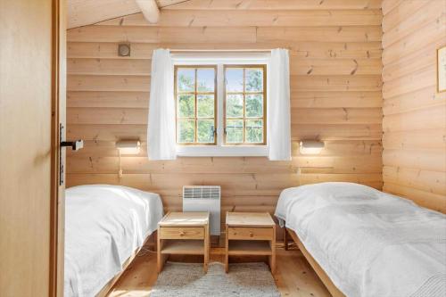 two twin beds in a room with a window at 1444-Aakirkeby-Poseregardsvejen-15 in Vester Sømarken