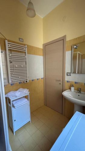 a bathroom with a sink and a toilet and a shower at La Lanterna Apartment in Canicattì