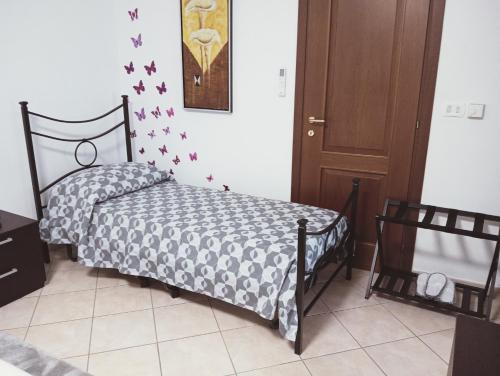 a bedroom with a bed with a black and white comforter at A casa di 'Nuccia' in Foglizzo