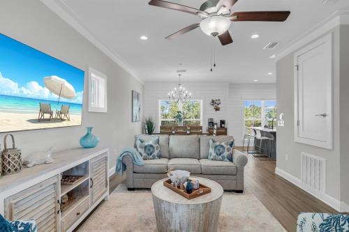 a living room with a couch and a table at Coastal Bummz in Orange Beach