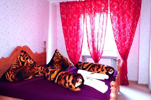 a bedroom with a bed with tigers pillows and a window at Holiday Rhein 3 in Boppard