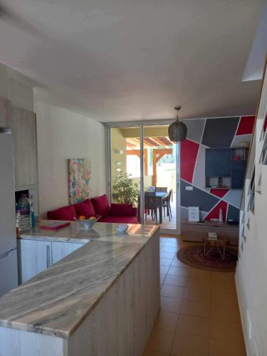 a kitchen with a counter and a living room at Charming Beach Villa Porto Santo in Porto Santo