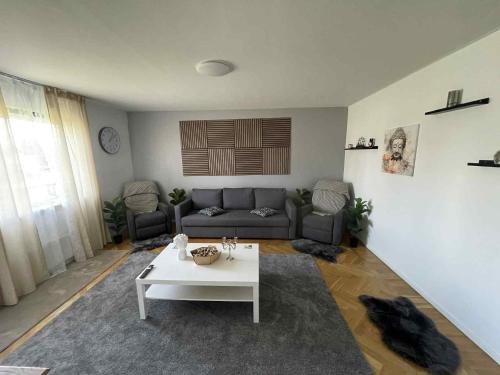 a living room with a couch and a coffee table at Cozy Apartment in Grimsås