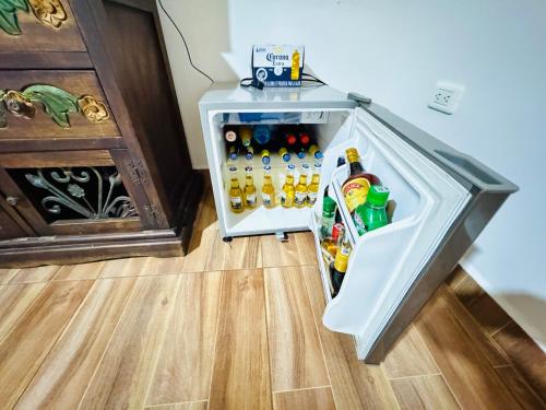 an open refrigerator filled with lots of drinks at Hostal Agroturistico Guadalupe in Saboyá