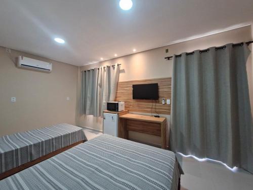 En eller flere senge i et værelse på Apartamento no centro da cidade