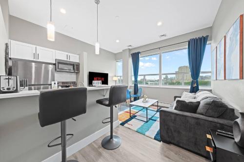 a kitchen and living room with a couch at 1BR • City Views • Queen + SofaBed • WiFi & 2 TVs in Cleveland