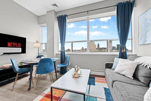 a living room with a couch and a table at 1BR • City Views • Queen + SofaBed • WiFi & 2 TVs in Cleveland