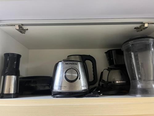 a toaster sitting on top of a shelf at Apartamento suíte com estacionamento in Porto Alegre
