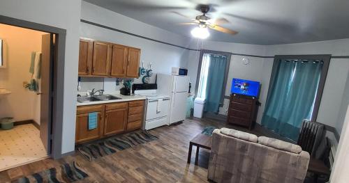 a living room with a kitchen and a couch at K2 Affordable 2nd Floor 1BR Near MTU w Keweenaw Fun 