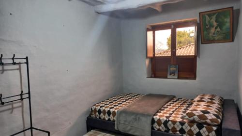 a bedroom with a bed in a room with a window at Casa turística la Nativa 