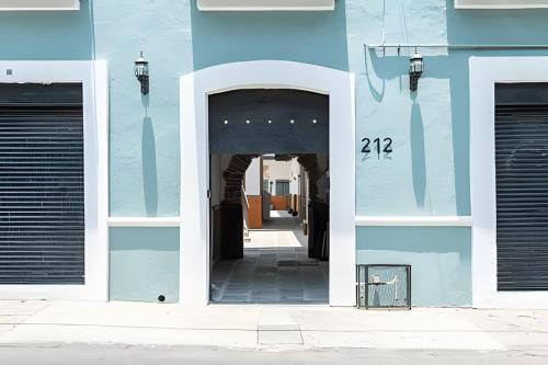 a blue building with an archway into a hallway at Casa 212 con WIFI alta velocidad y estacionamiento in Puebla