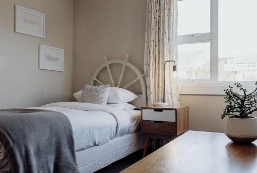 a bedroom with a white bed and a window at Hokitika Beach Break in Hokitika