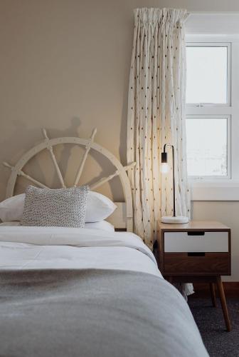 a bedroom with a large bed and a window at Hokitika Beach Break in Hokitika