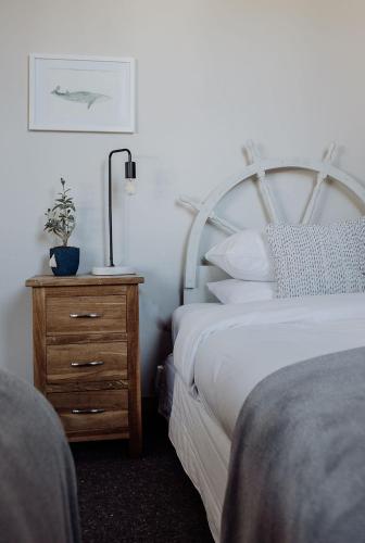 a bedroom with a bed and a night stand with a plant at Hokitika Beach Break in Hokitika
