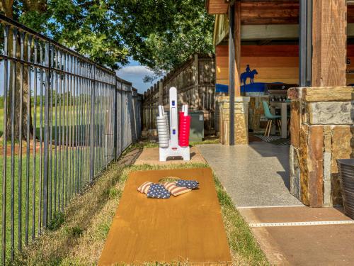 a wooden ramp with a picture of a person on it next to a fence at The Big Friendly - A family retreat, heated pool, hot tub, game room minutes away from DT OKC in Oklahoma City