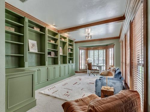 a living room with green shelves and a blue couch at The Big Friendly - A family retreat, heated pool, hot tub, game room minutes away from DT OKC in Oklahoma City