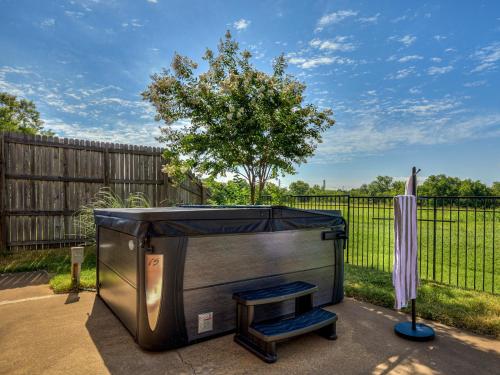 a large tv sitting in front of a fence at The Big Friendly - A family retreat, heated pool, hot tub, game room minutes away from DT OKC in Oklahoma City