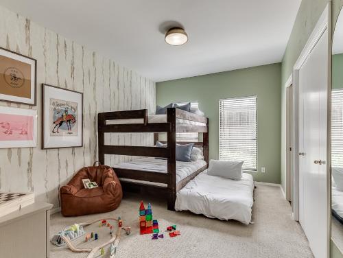 a bedroom with two bunk beds and toys in it at The Big Friendly - A family retreat, heated pool, hot tub, game room minutes away from DT OKC in Oklahoma City