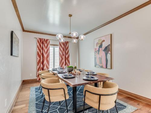 a dining room with a table and chairs at The Big Friendly - A family retreat, heated pool, hot tub, game room minutes away from DT OKC in Oklahoma City