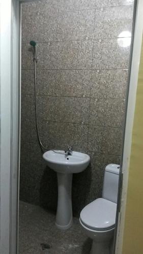 a bathroom with a toilet and a sink at House near The Black Sea in Makhinjauri