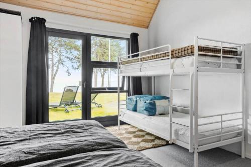 a bedroom with two bunk beds and a window at LF15210-Hojslev-Jelsevej-210 in Højslev