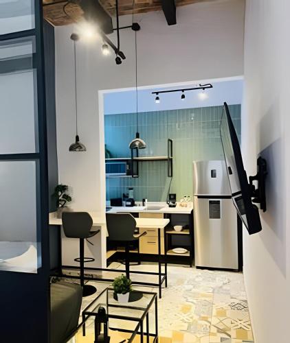 a kitchen with a table and a refrigerator at Casa 212 con WIFI alta velocidad y estacionamiento in Puebla
