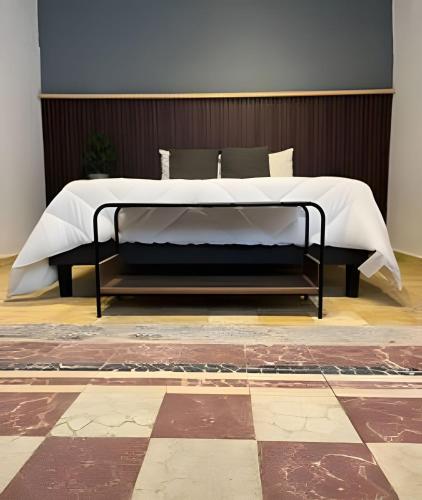 a bed in a bedroom with a checkered floor at Casa 212 con WIFI alta velocidad y estacionamiento in Puebla