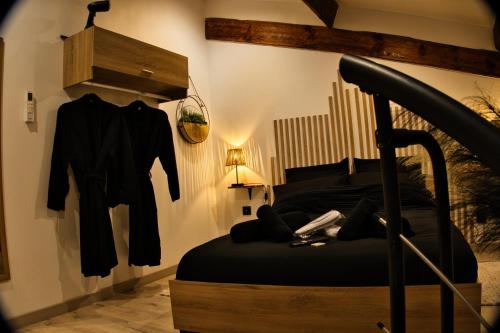a bedroom with a bed and clothes hanging on a wall at CocooningRoom - Tain L'hermitage in Tain-lʼHermitage