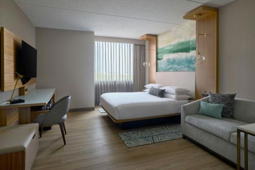 a hotel room with a bed and a couch at Chicago Marriott Northwest in Hoffman Estates