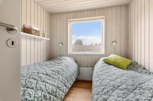 a bedroom with two beds and a window at LF16021-Farso-Kjeldhoj-121 in Farsø
